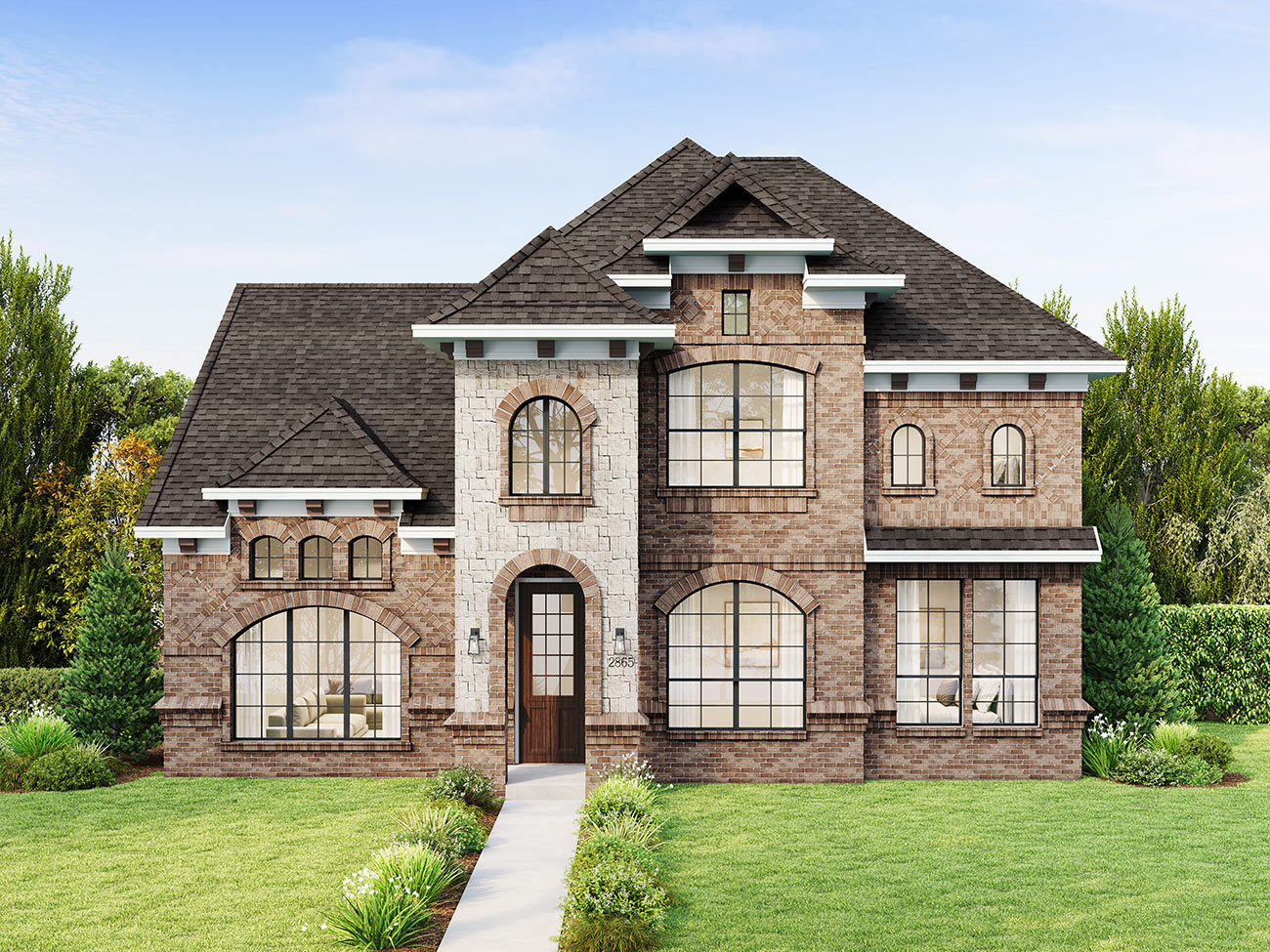 Classic estate-style brick home with arched windows, stone detailing and symmetrical facade