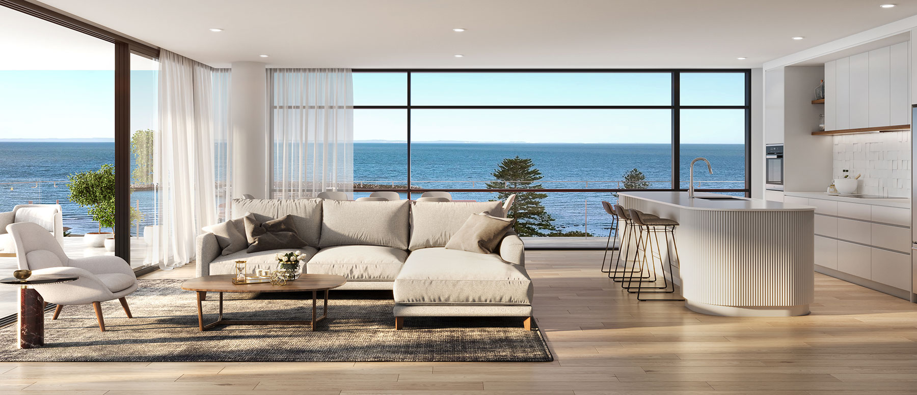 Luxury open plan living and kitchen with ocean views, large glazing and modern interior finishes