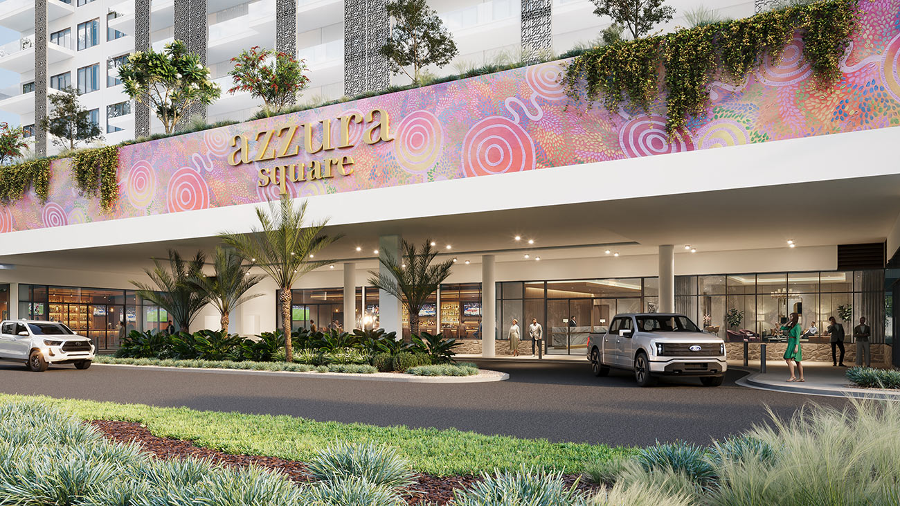 Retail and commercial development entrance with landscaping and signage