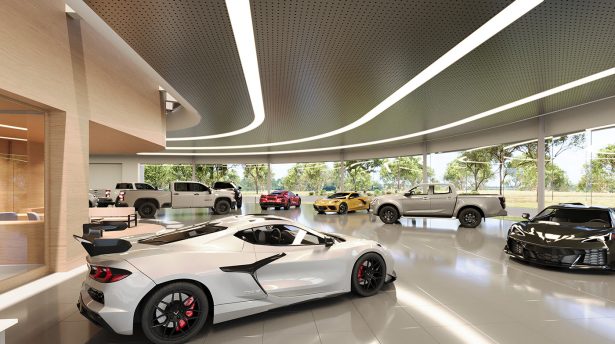 Automotive showroom interior displaying performance vehicles with open layout and natural lighting