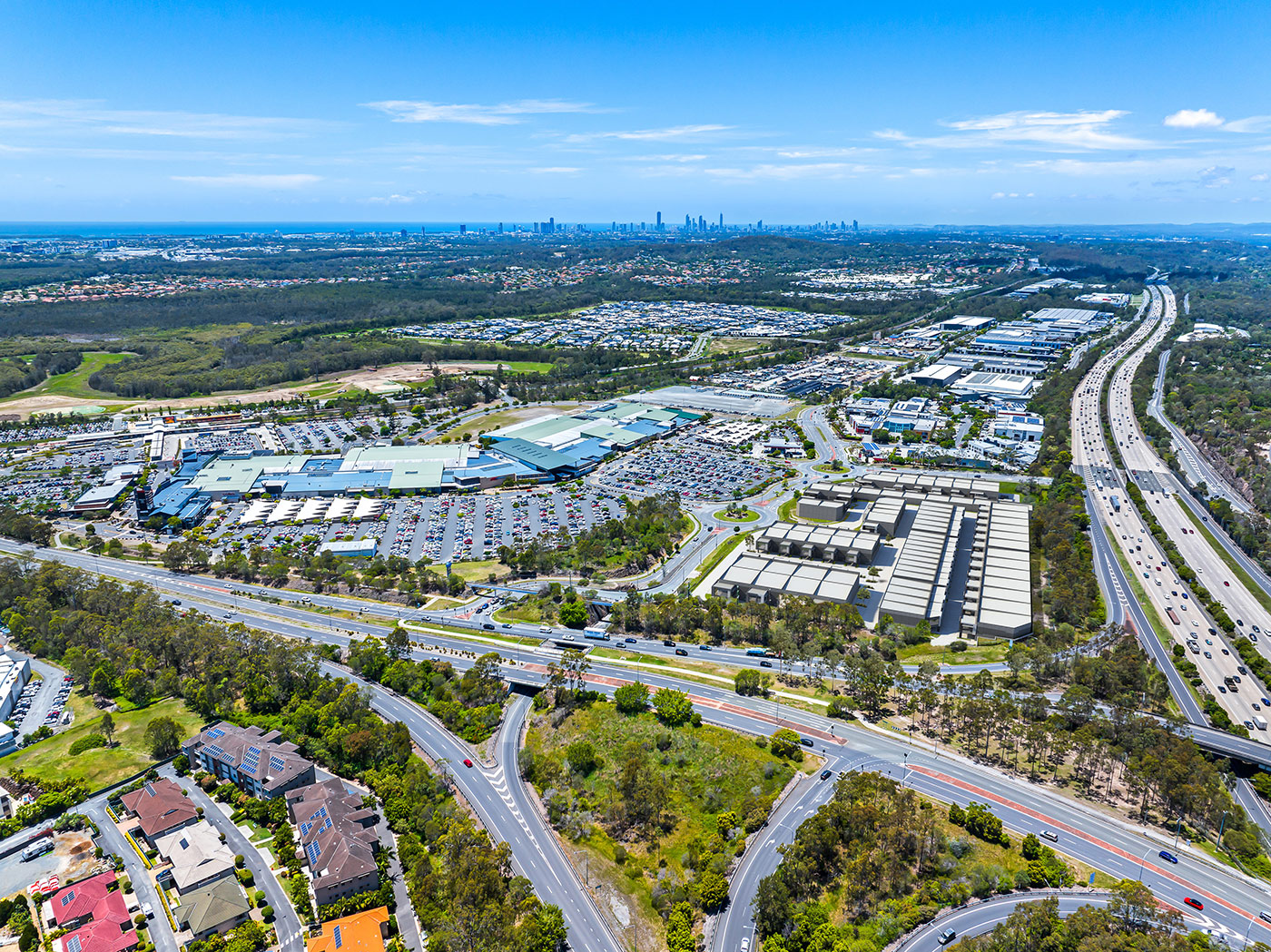 Aerial view of industrial development site in Helensvale with surrounding roads, retail precinct and urban context