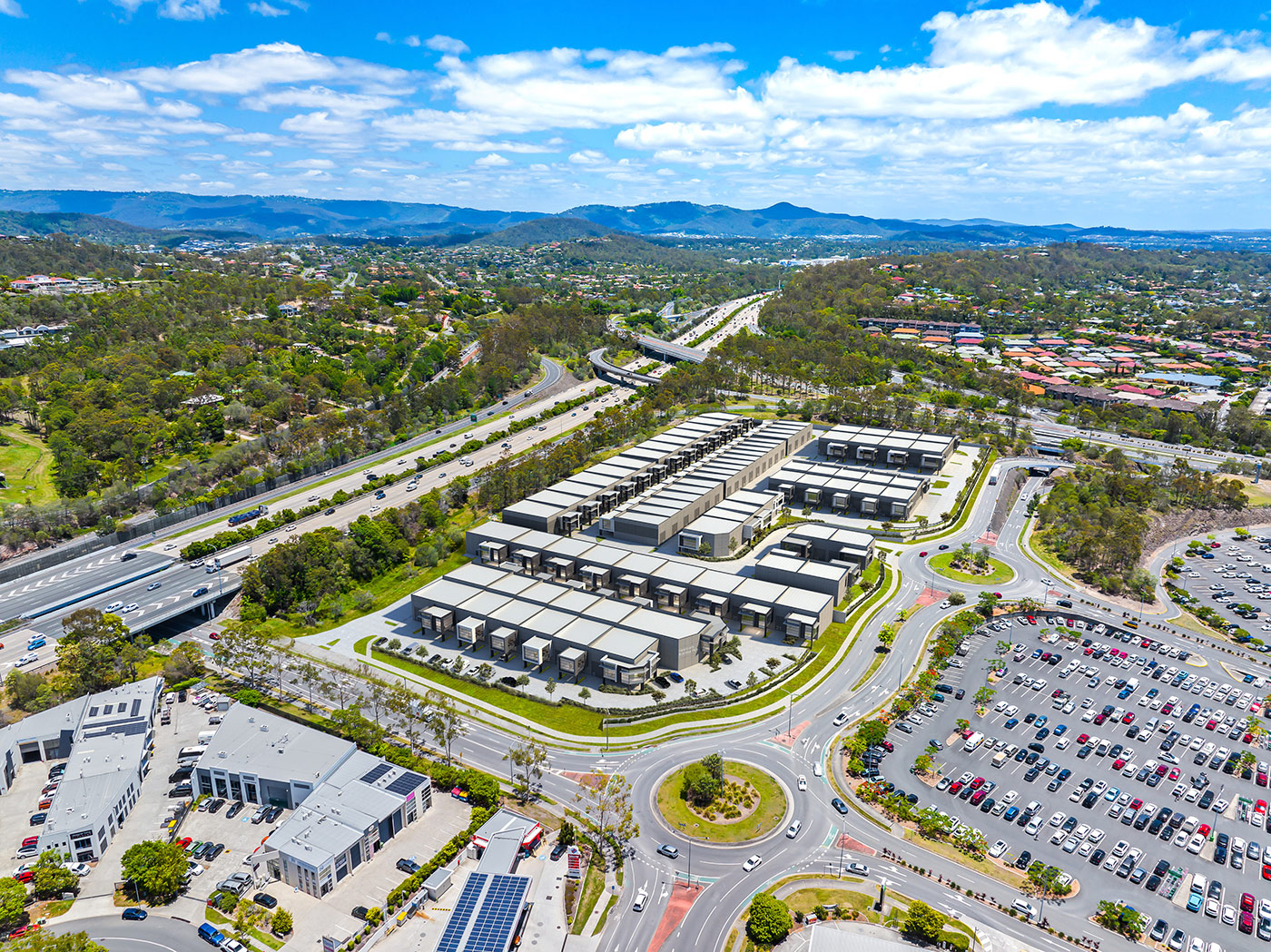 Aerial render of modern industrial storage unit development with road access and landscaped layout in Helensvale