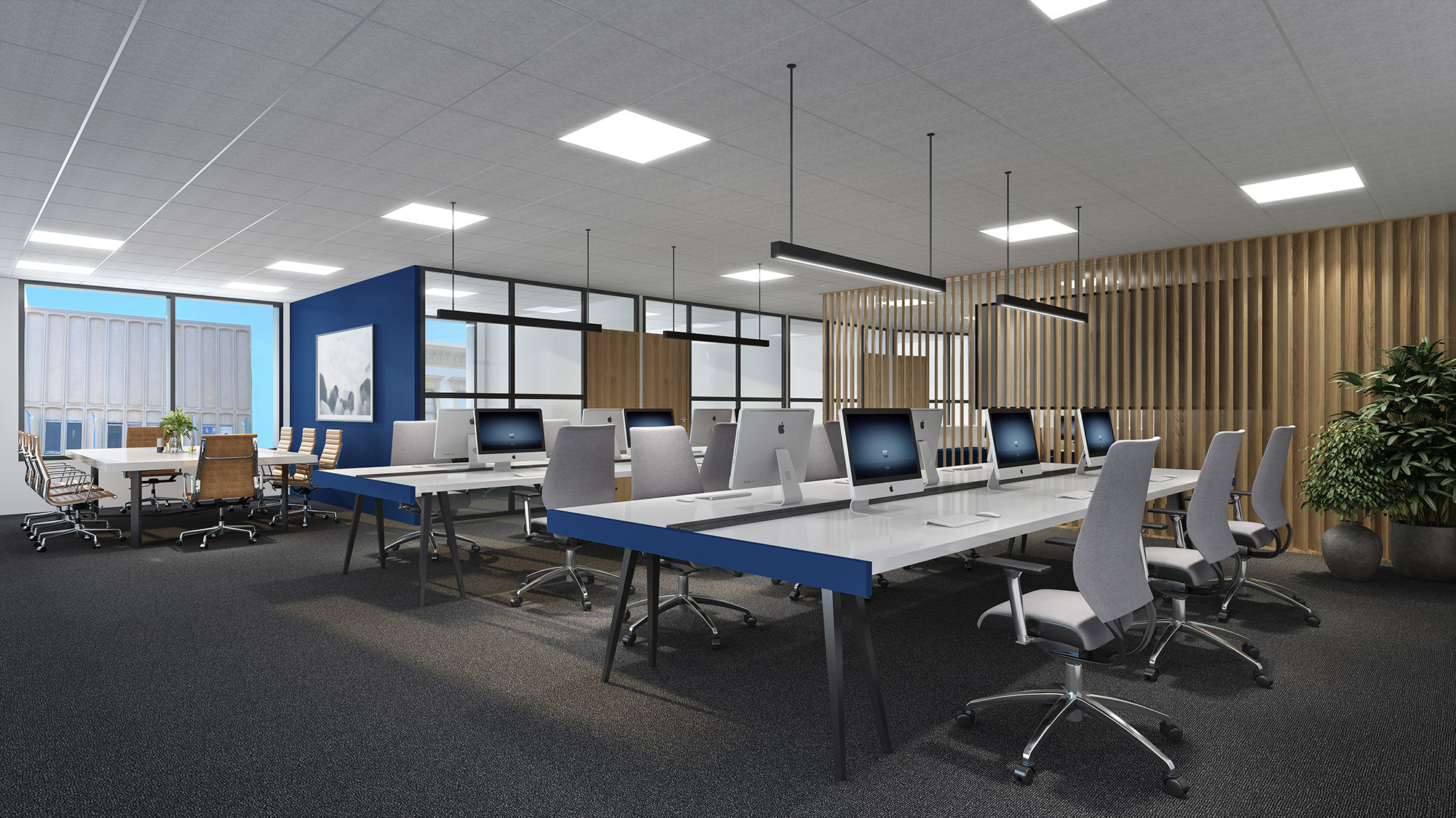 Office interior featuring suspended linear lighting system over collaborative workspace