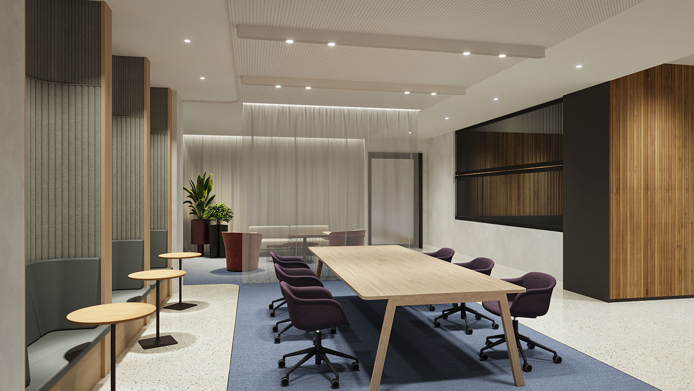 Open collaborative workspace with large meeting table, soft seating lounge and layered architectural finishes